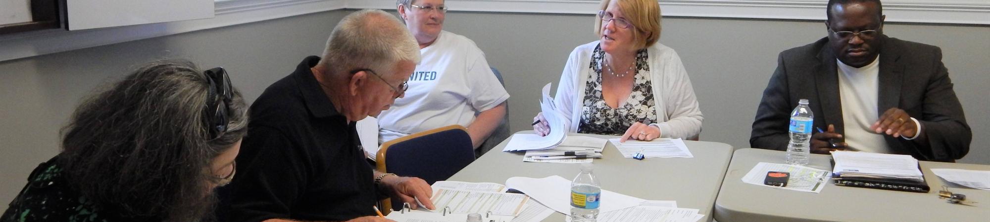 Impact Council members meet at a table