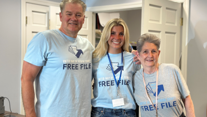 Three tax volunteers wearing Free File tshirts pose